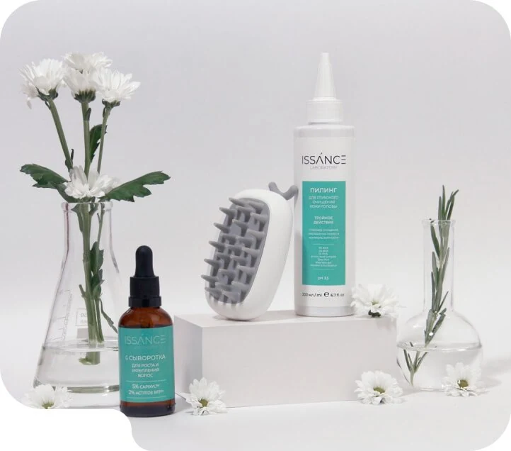 ISSANCE hair serum and scalp peeling with a scalp brush and white flowers